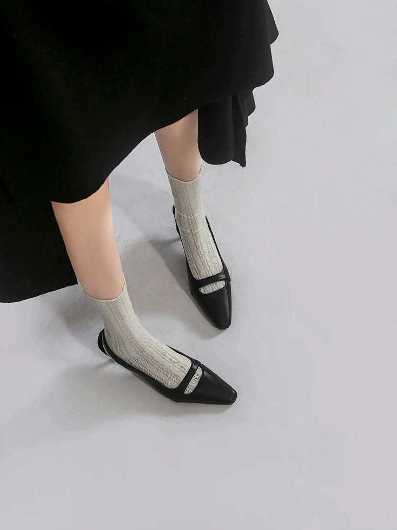 Pair of black square-toe slingback heels shown from the side with a slim front vamp strap, smooth matte finish, open heel, and low kitten heel