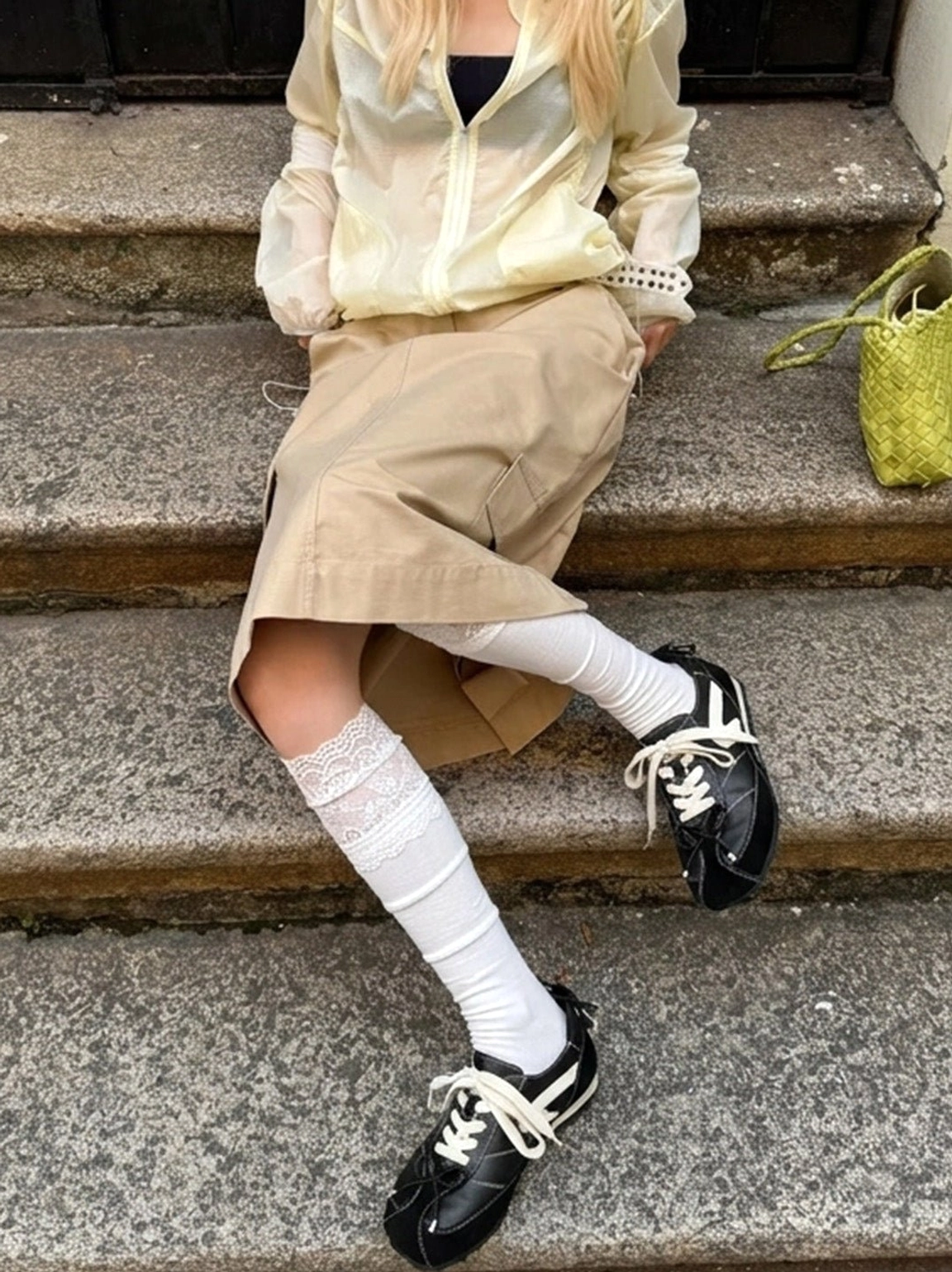 Black square-toe sport ballet flats styled with a skirt and ruffled socks in a casual Korean streetwear outfit