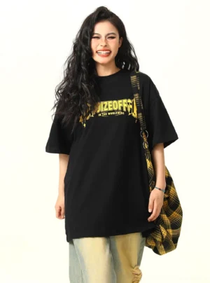 Black oversized star graphic streetwear t-shirt front three-quarter view with plaid crossbody bag