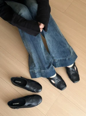 Black square toe star panel leather ballet flats styled with vintage washed flared denim jeans