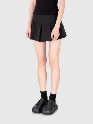 Woman wearing black star platform sandals with ankle socks pleated mini skirt and cropped top in a Seoul streetwear outfit
