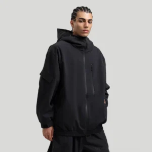 Black hooded storm shell jacket with hidden front zipper, compact chest pocket, and relaxed techwear streetwear fit