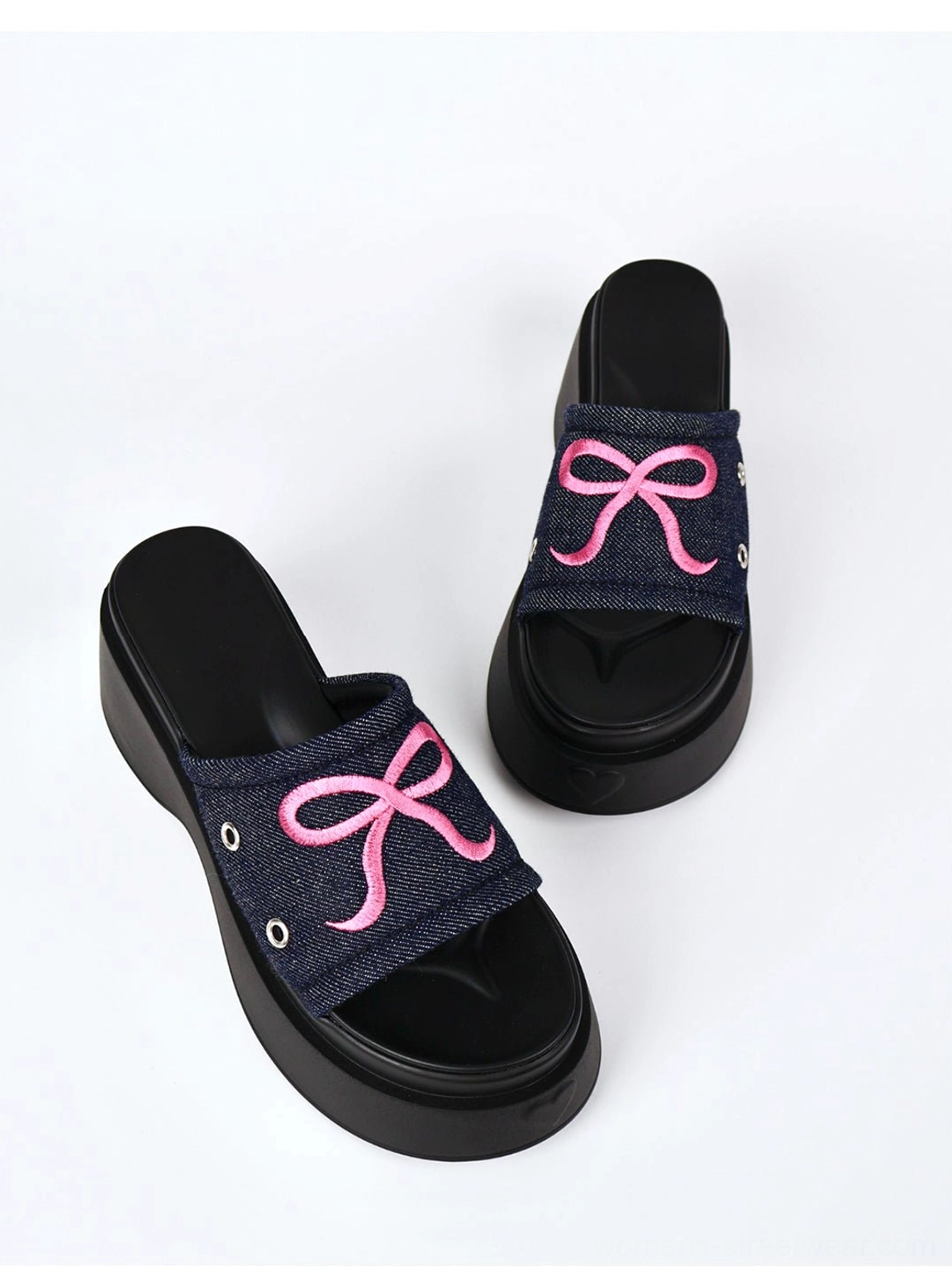 Black strap and hot pink platform bow sandals with open toe slip-on construction