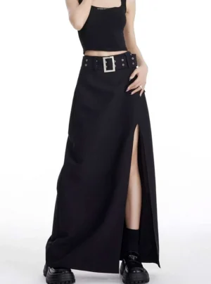 Three-quarter view of black streetwear maxi skirt with high side slit, silver grommet belt and platform shoes