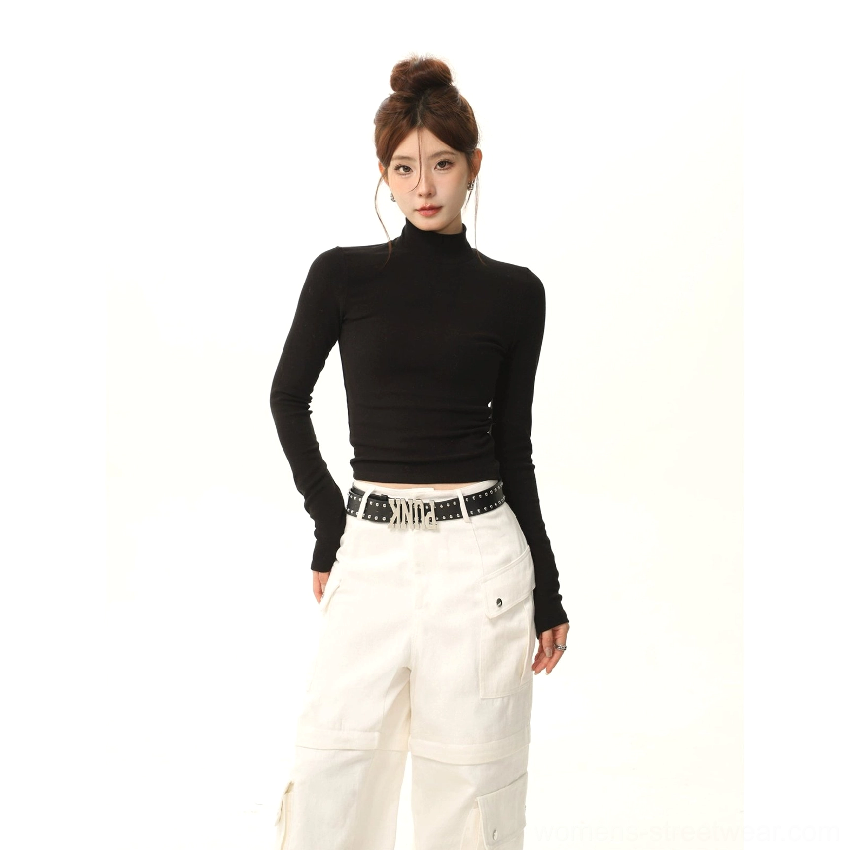 Black stretch mock neck slim fit long sleeve streetwear top styled with white wide-leg cargo pants and studded belt