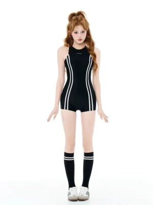 Front view of a black stripe swim romper with white side stripes, high neckline, sleeveless racer-style armholes, and short boyleg coverage