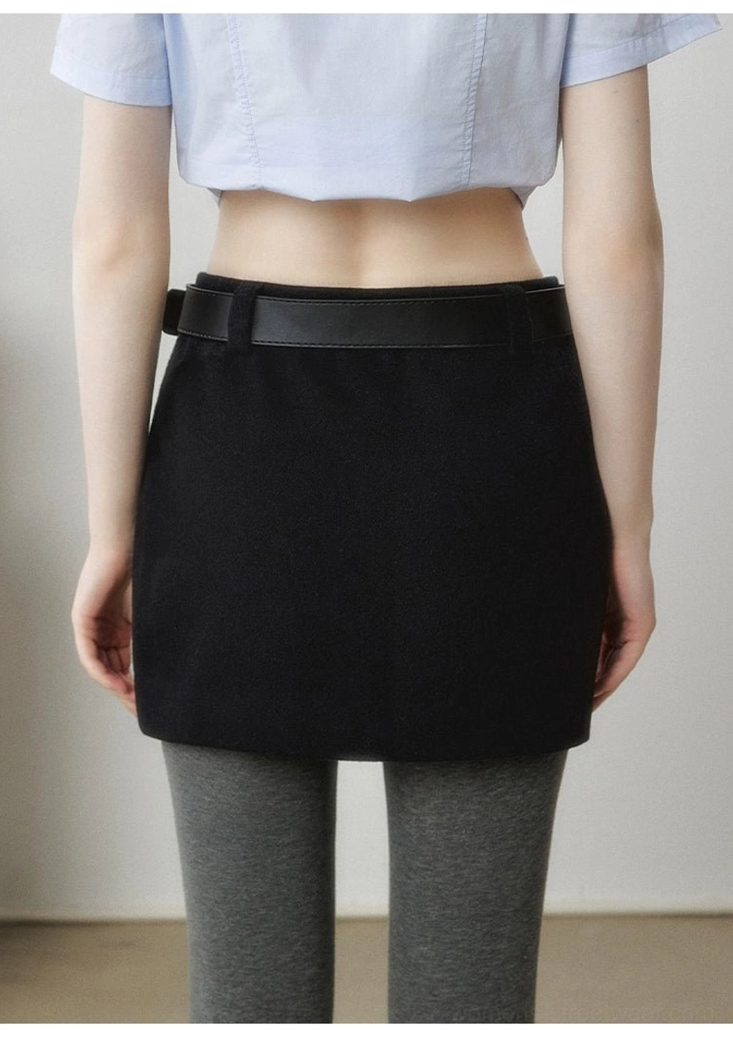 Black structured mini skirt with belt-style waistband shown from a slight side angle in modern Korean streetwear styling