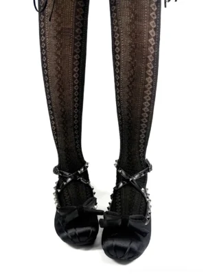 Black studded bow satin ballet flats worn with diamond patterned sheer black tights in a front overhead streetwear styling view