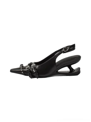 Black studded buckle pointed-toe slingback heels shown in a flat side view with dual buckle straps and sculpted low heel