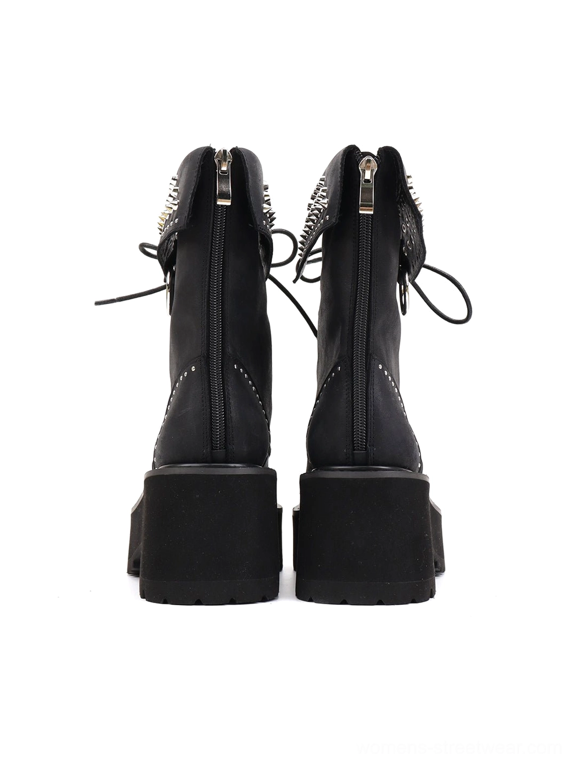Rear view of black distressed leather combat boots featuring studded ankle cuffs, rear zipper closure, block platform heel, and lug tread