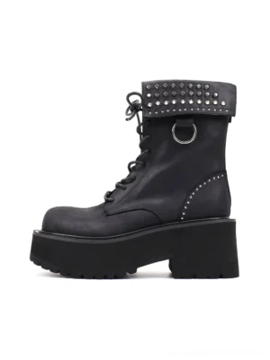 Side profile of black studded distressed leather platform combat boots with fold-over cuff, extended laces, metal D-ring, rounded toe, and chunky lug sole