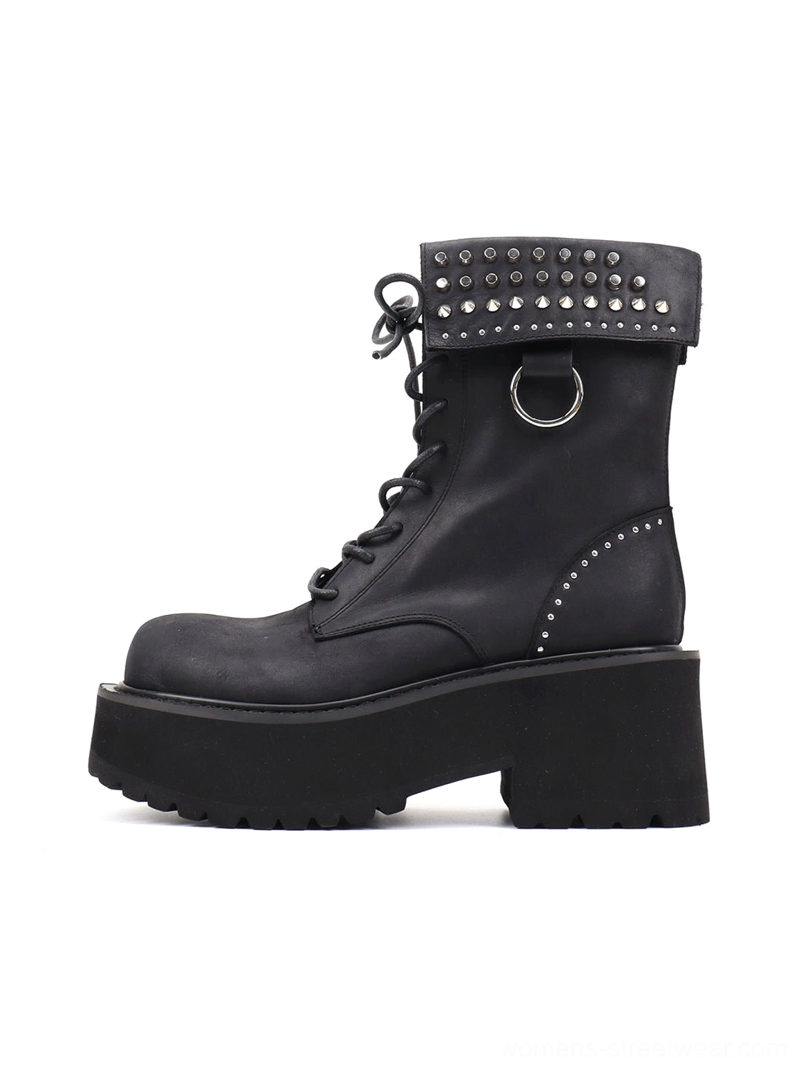 Side profile of black studded distressed leather platform combat boots with fold-over cuff, extended laces, metal D-ring, rounded toe, and chunky lug sole