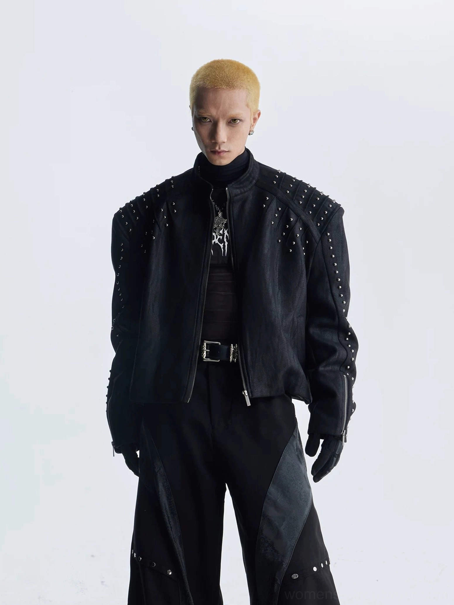 Black studded faux leather moto jacket detail with padded shoulders metallic rivets and clean front zipper