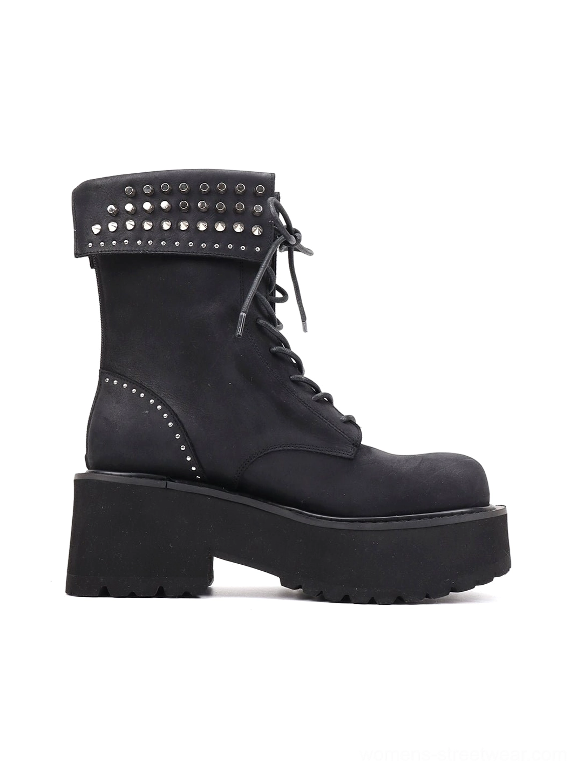 Three-quarter rear view of a black studded leather combat boot with distressed finish, chunky platform sole, ankle cuff, and heel counter studs