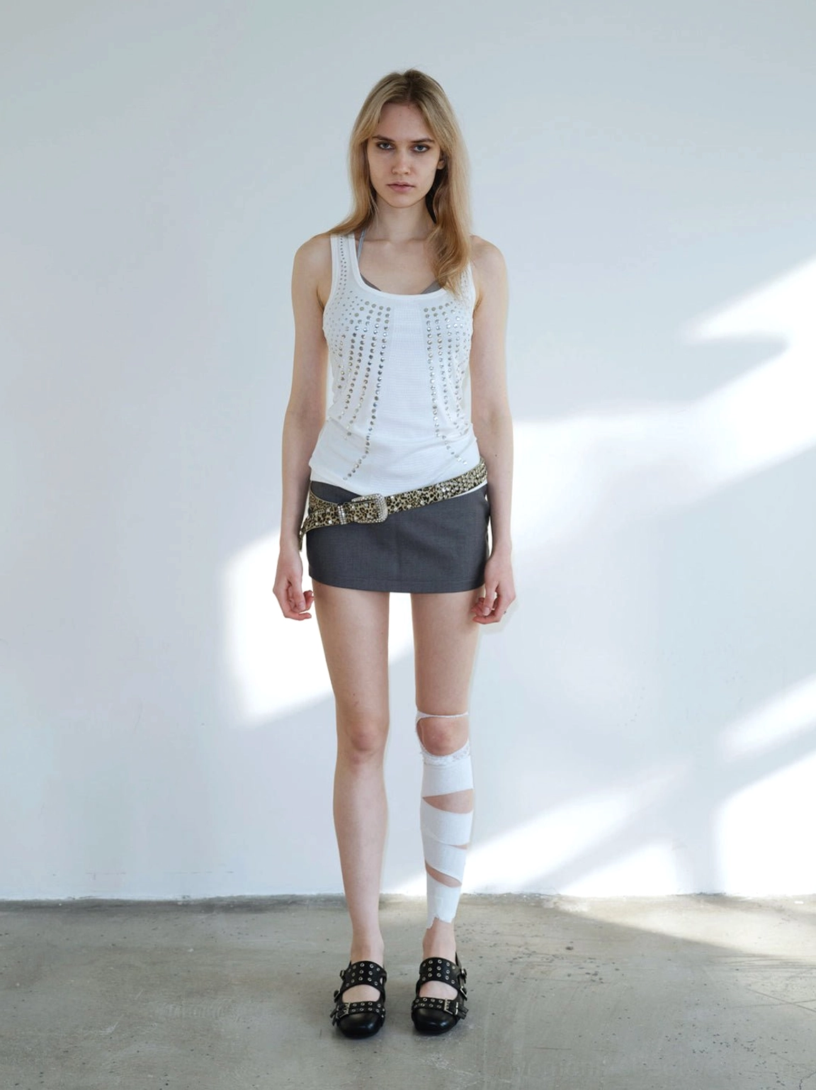 Black studded platform Mary Jane flats with mini skirt, waist belt, and alternative goth streetwear styling