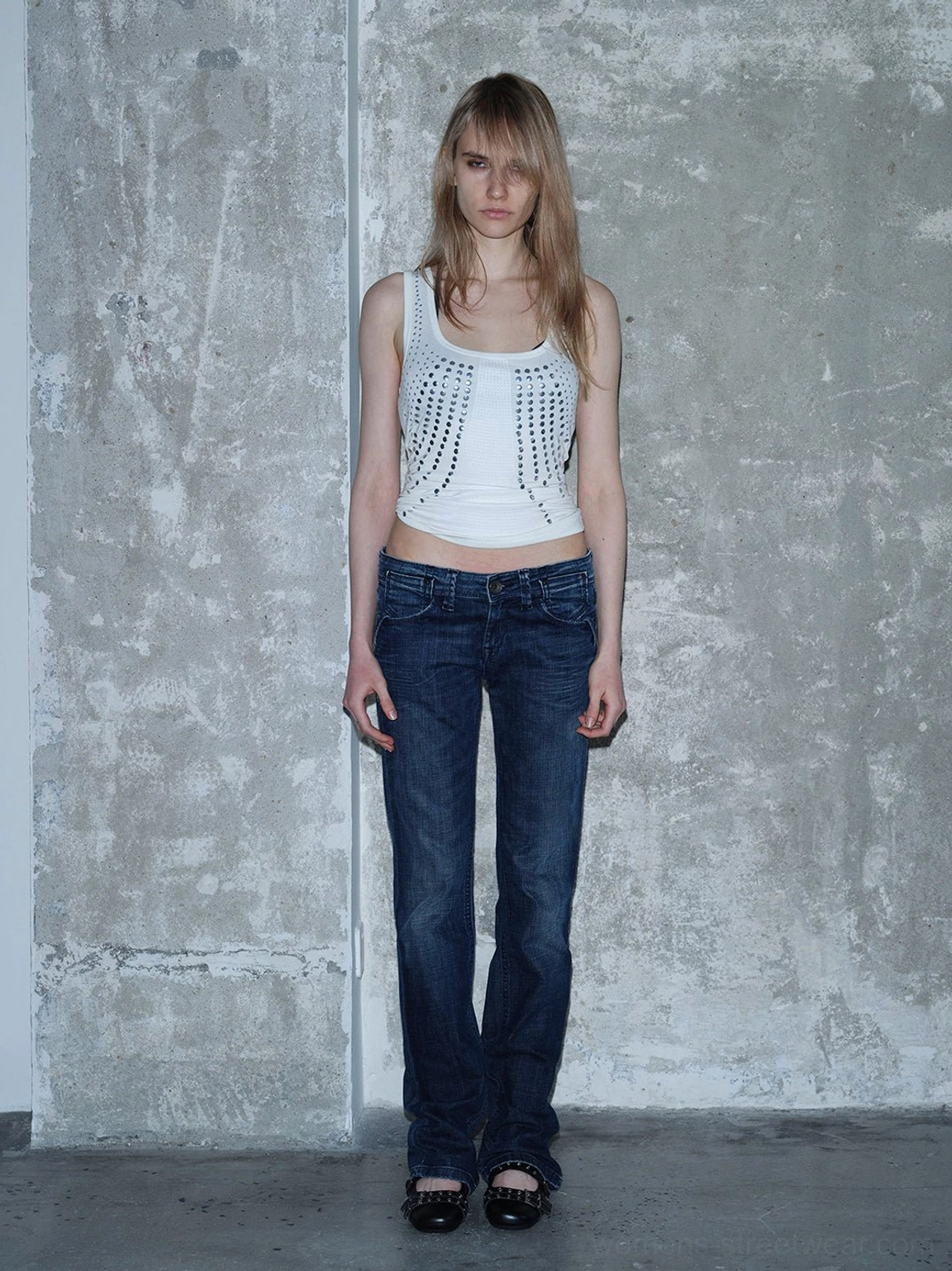 Black studded platform Mary Jane flats paired with straight-leg jeans for minimalist everyday goth streetwear