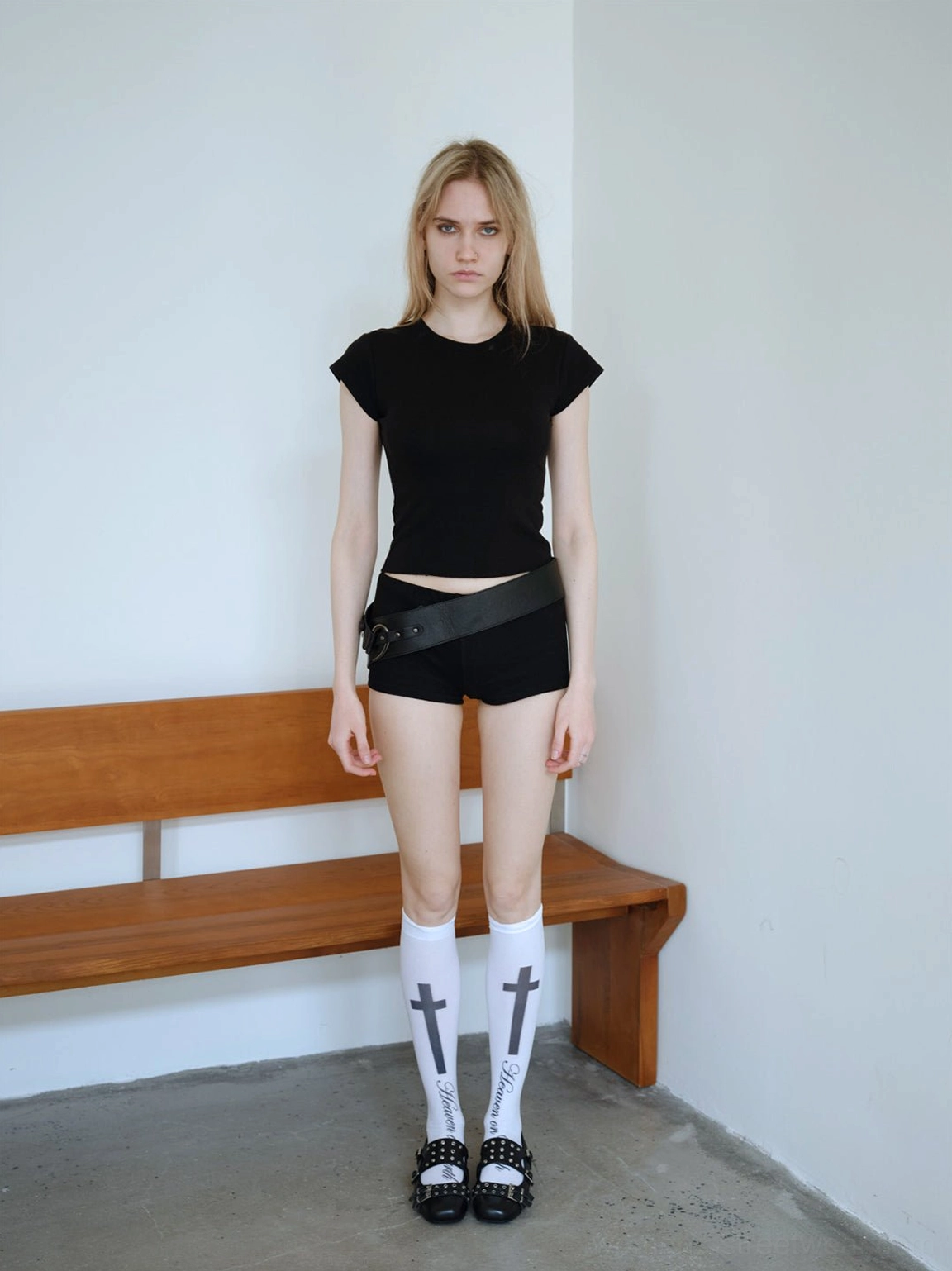Black studded platform Mary Jane flats completing a black Y2K goth streetwear outfit with cross print socks