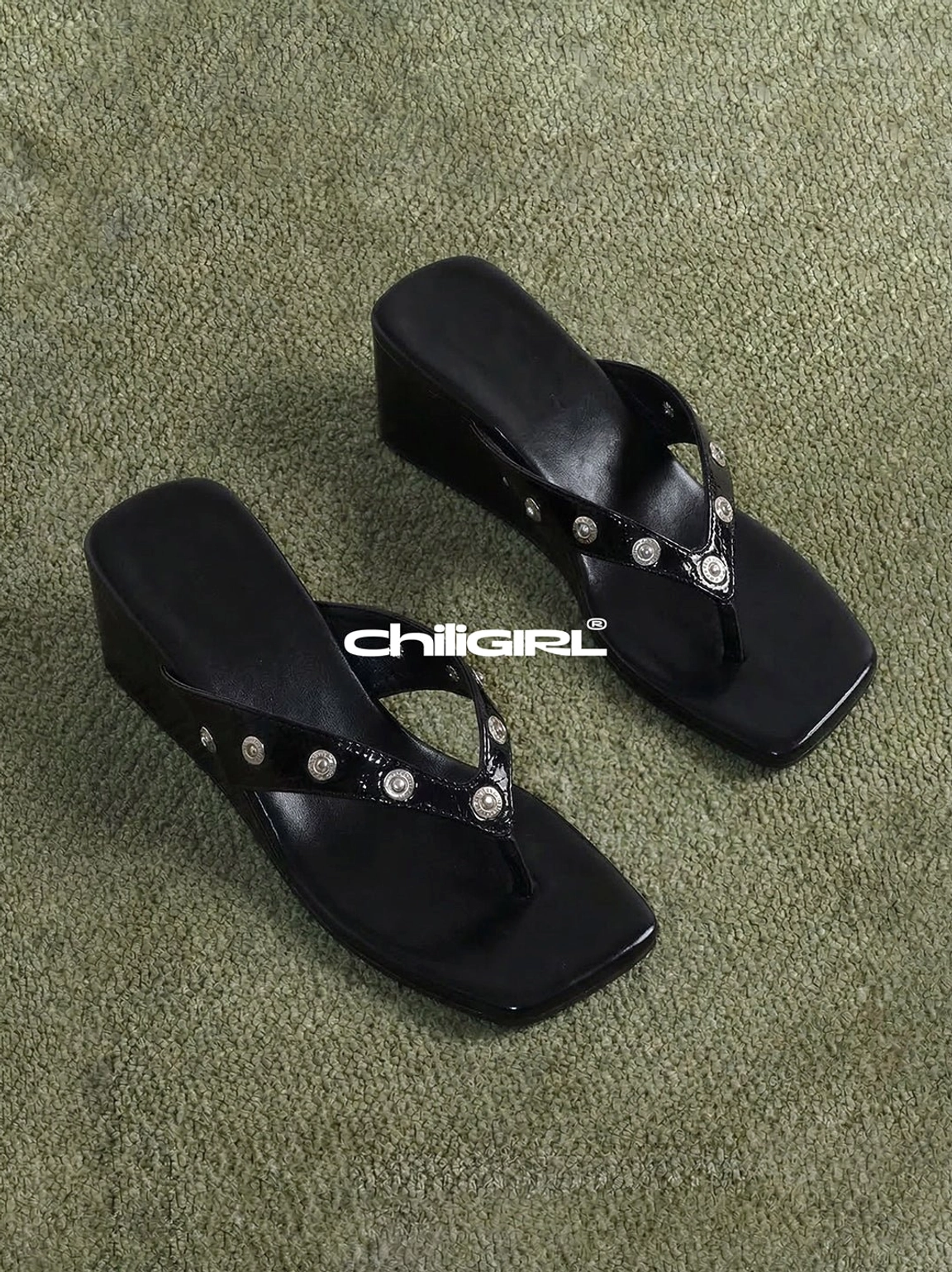 Black studded platform thong sandals with buckle details, square open toe, polished silver accents, and low wedge streetwear sole