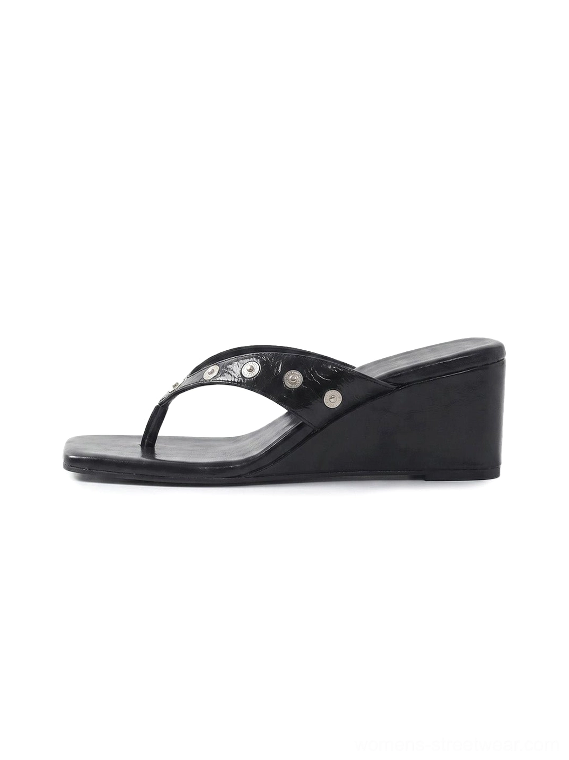 Black studded platform thong sandals with glossy PU straps, polished silver studs, square open toe, and low wedge sole shown in a side product view