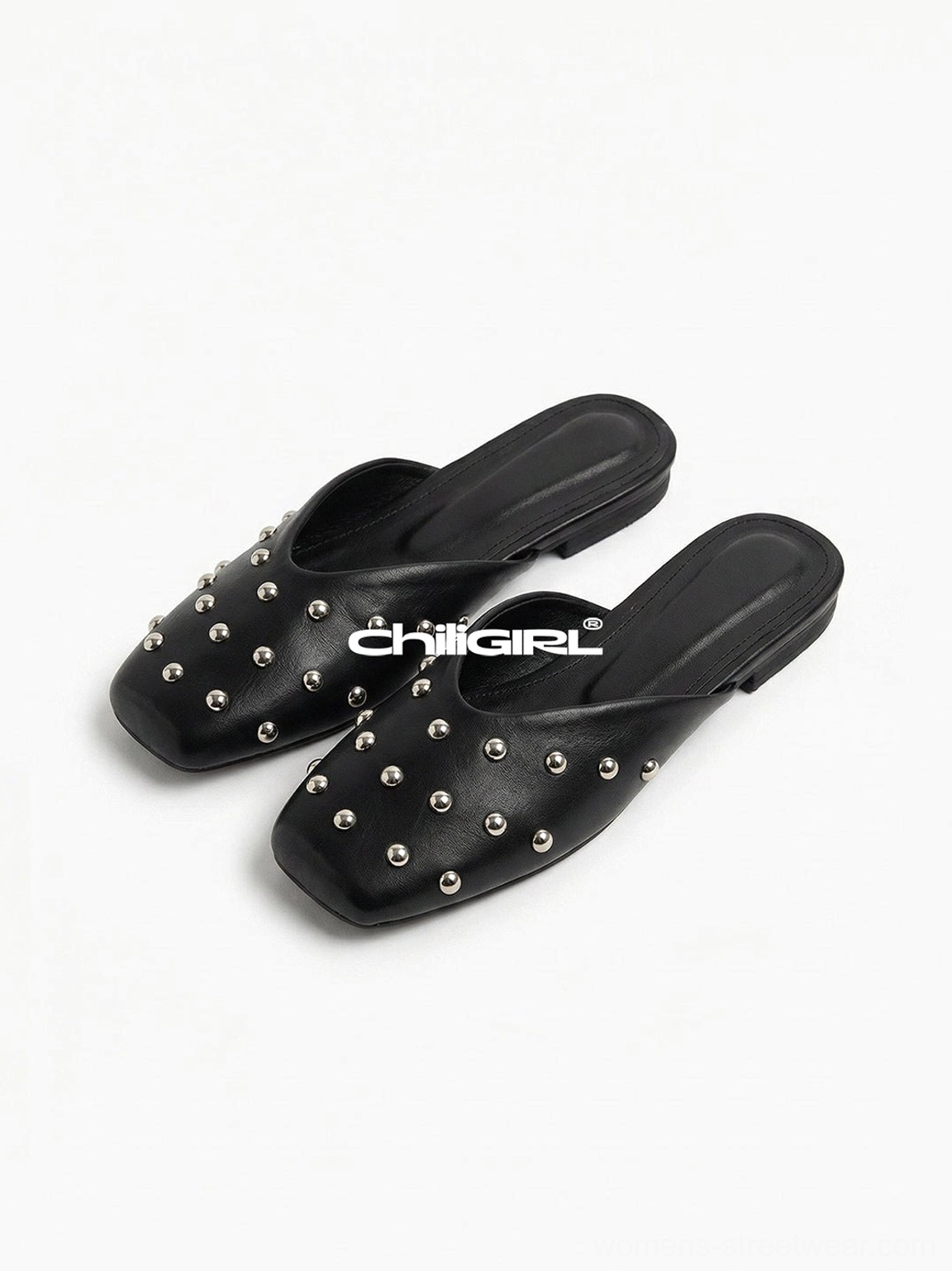 Black studded pointed-toe mule flats with silver-tone rivet details and open-back slip-on design