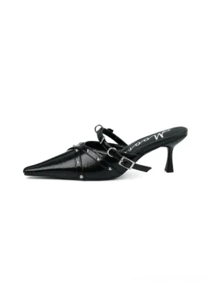 Black studded pointed-toe slingback kitten heels shown in a side profile with buckle strap and polished metal studs