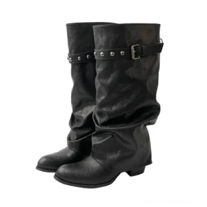 Black studded strap slouch tall boots shown from the front with pointed toes, relaxed shafts, low block heels, and removable buckle details
