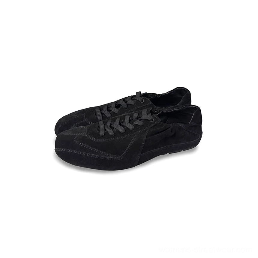 Black suede minimalist lace-up sneakers with a clean German trainer-inspired silhouette for everyday streetwear styling