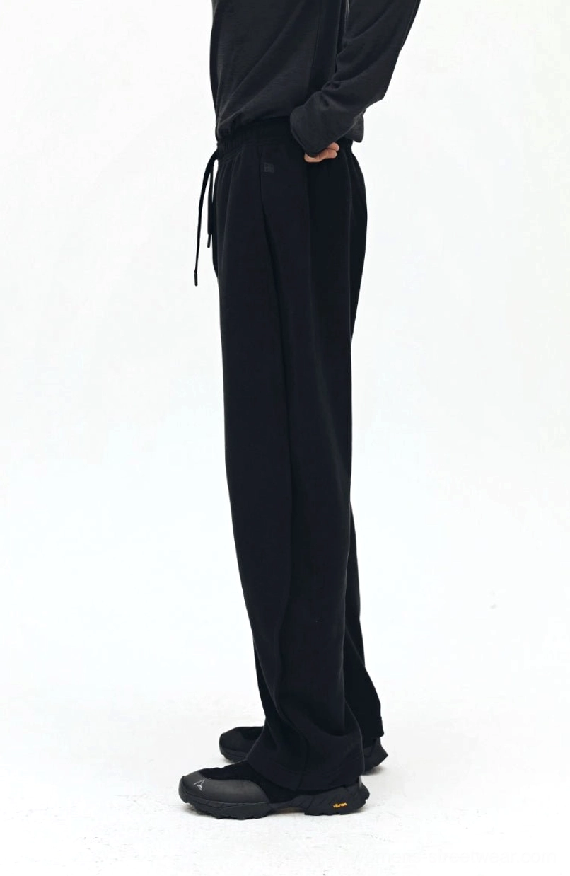 Black sweatpants pocket placement and design - functional streetwear pants with practical details