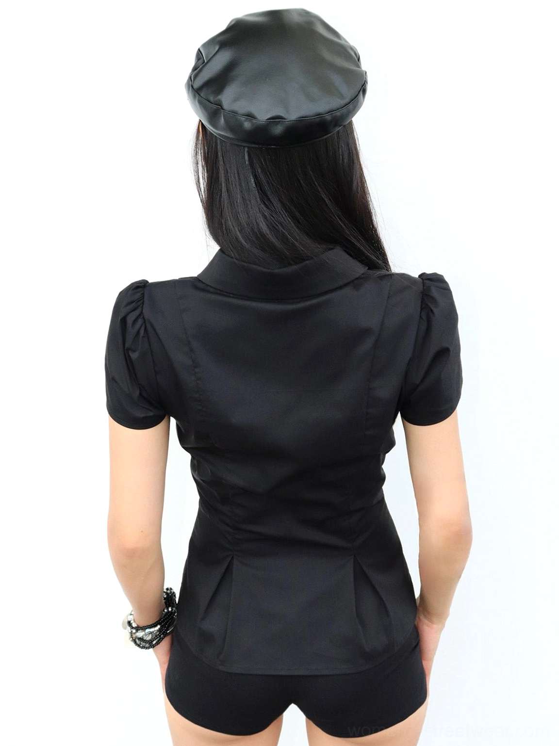 Back view of black tailored puff-sleeve blouse with waist darts and curved hem