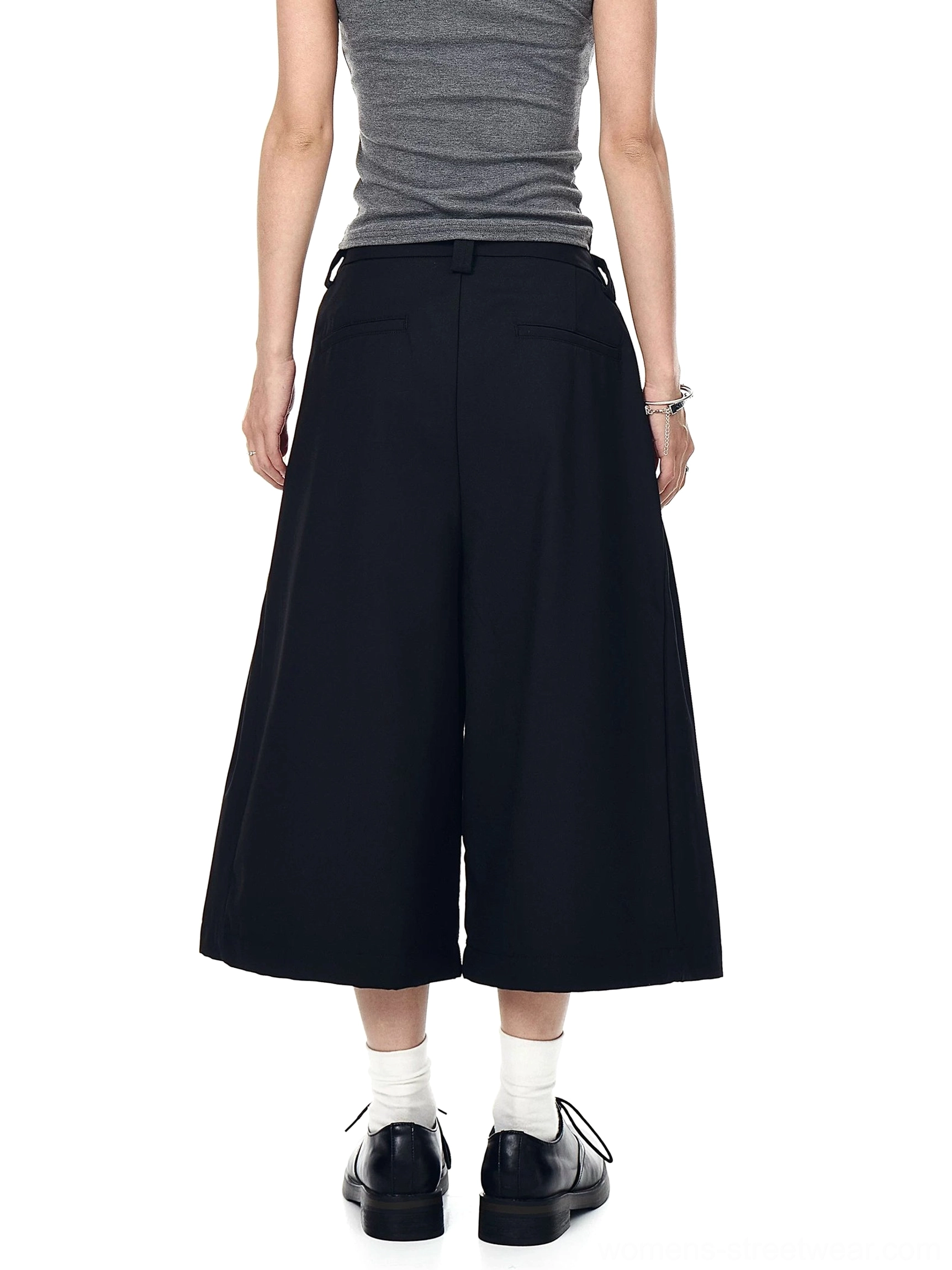 Black tailored wide-leg cropped trousers shown from the back with a clean waistband, back pocket, and minimalist streetwear finish