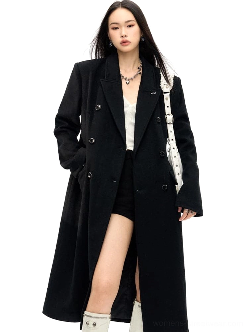 Black tailored wool long coat featuring a notched lapel, double-breasted buttons and flap waist pockets
