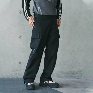 Black techwear waterproof cargo pants shown from a partial front side view with large cargo pockets, side-leg zippers, and a loose tactical silhouette