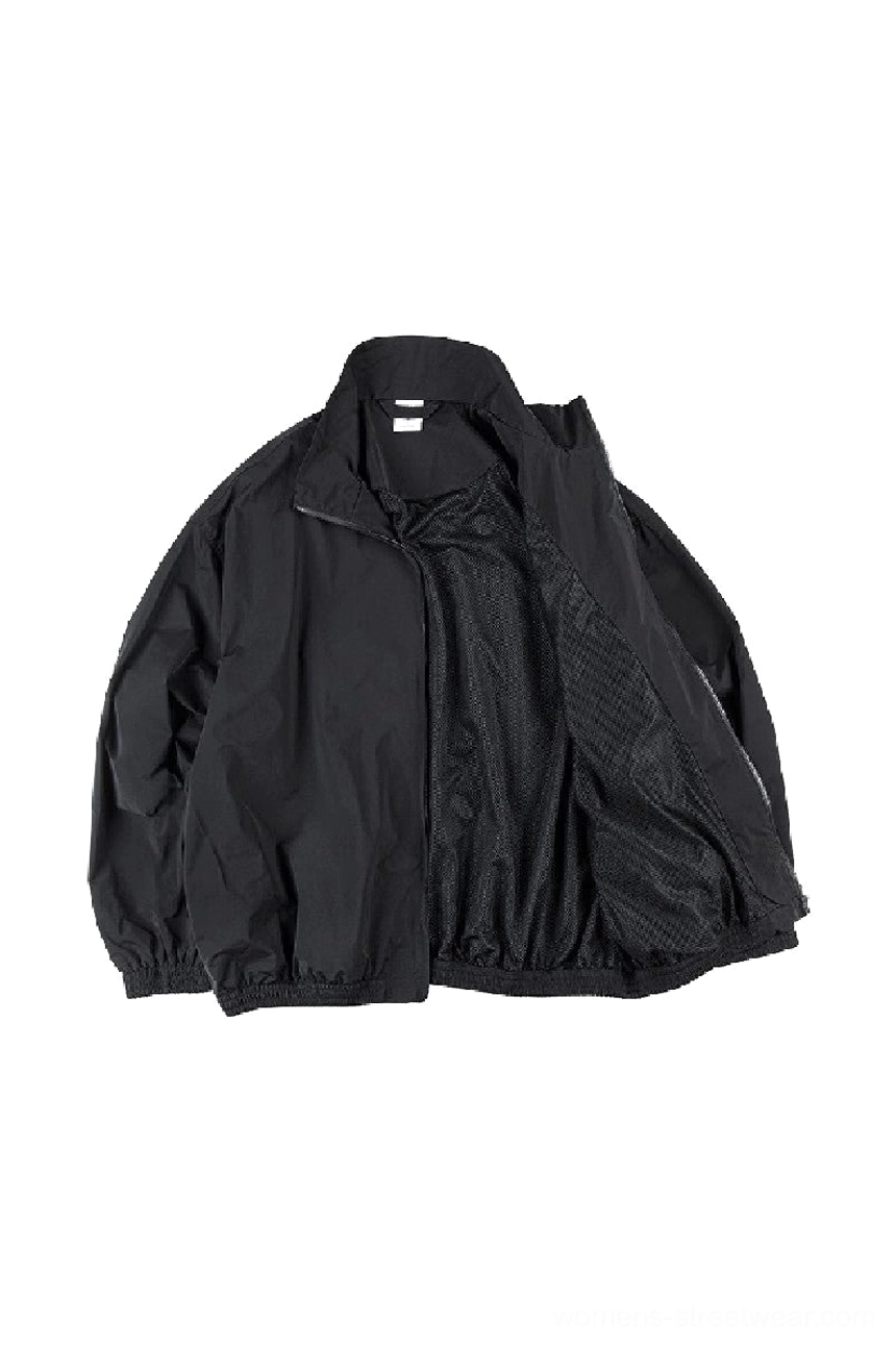 Black techwear windbreaker jacket shown open with breathable mesh lining and dropped shoulder design