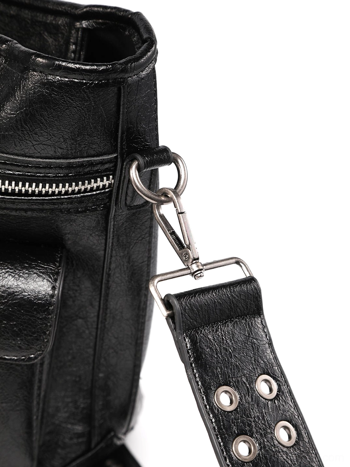 Close-up of black textured cracked leather tote bag side panel, silver strap attachment hardware, and zippered top opening