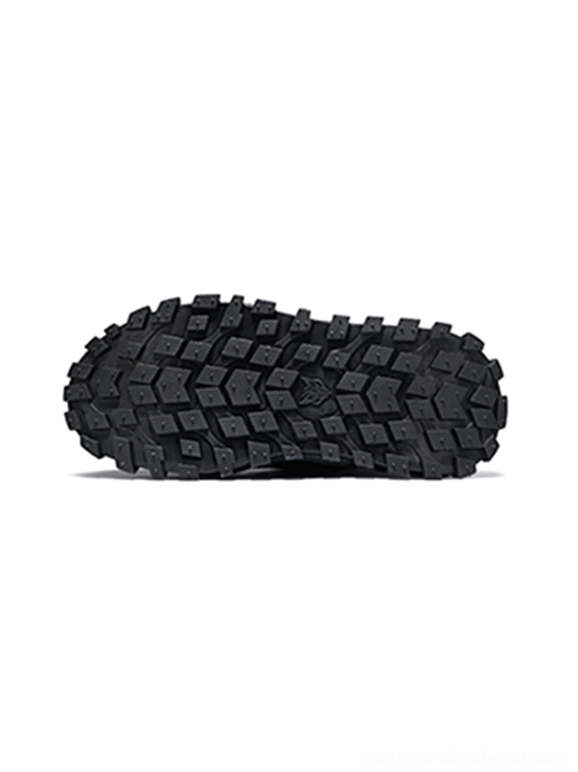 Black trail platform sneaker outsole close-up showing aggressive multidirectional lug tread pattern
