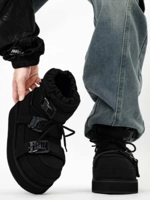 Black triple-buckle platform snow boots worn with blue jeans, showing padded moon-boot silhouette, side profile, back view, lace-up front and fleece collar