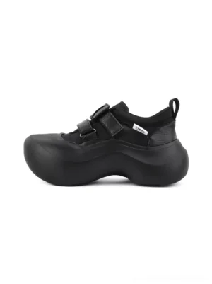 Black triple-strap sculpted platform shoes for women in left side product view showing the rounded toe and chunky curved sole