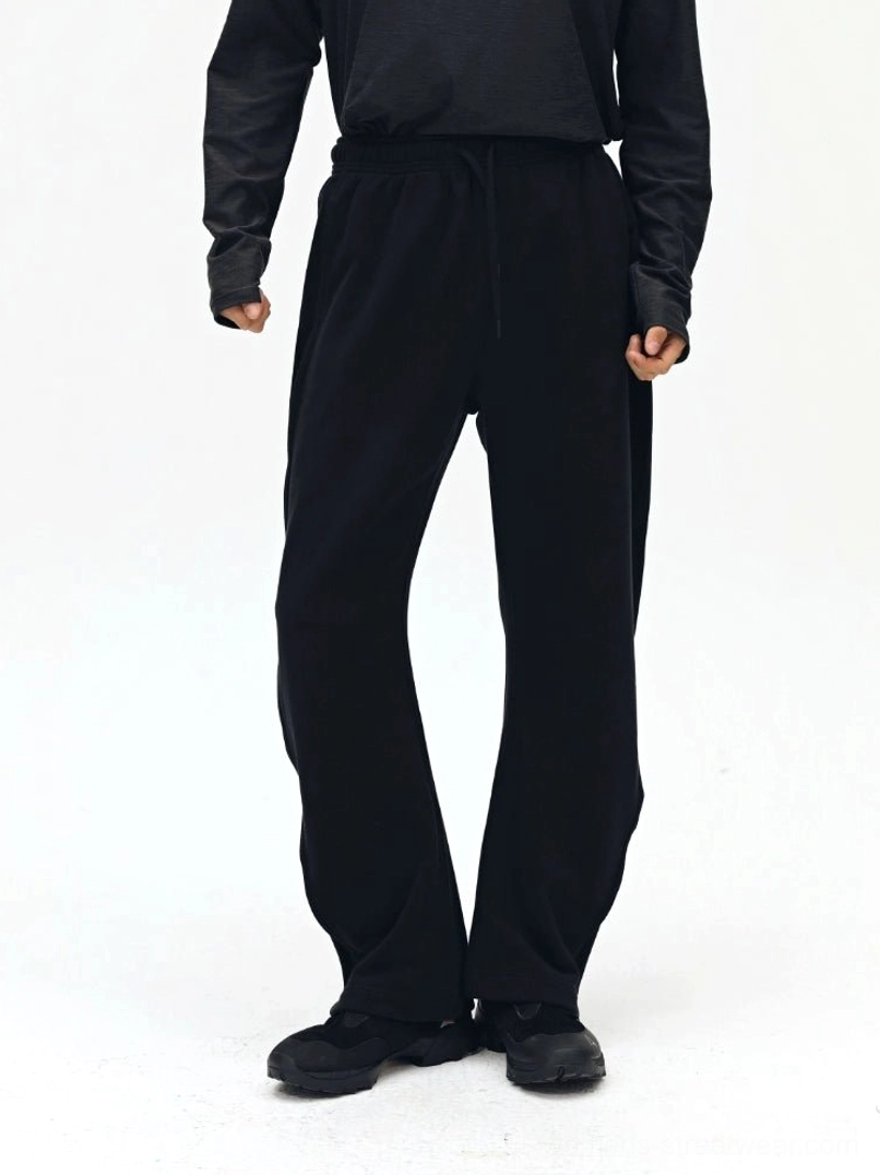 Black twill drawstring sweatpants front view - relaxed fit streetwear essentials with twisted bone seam design