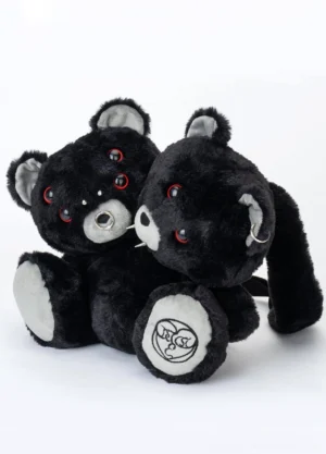 Front flat lay of black twin evil bear faux fur mini backpack with red ring eyes metal facial piercings and embroidered paw details
