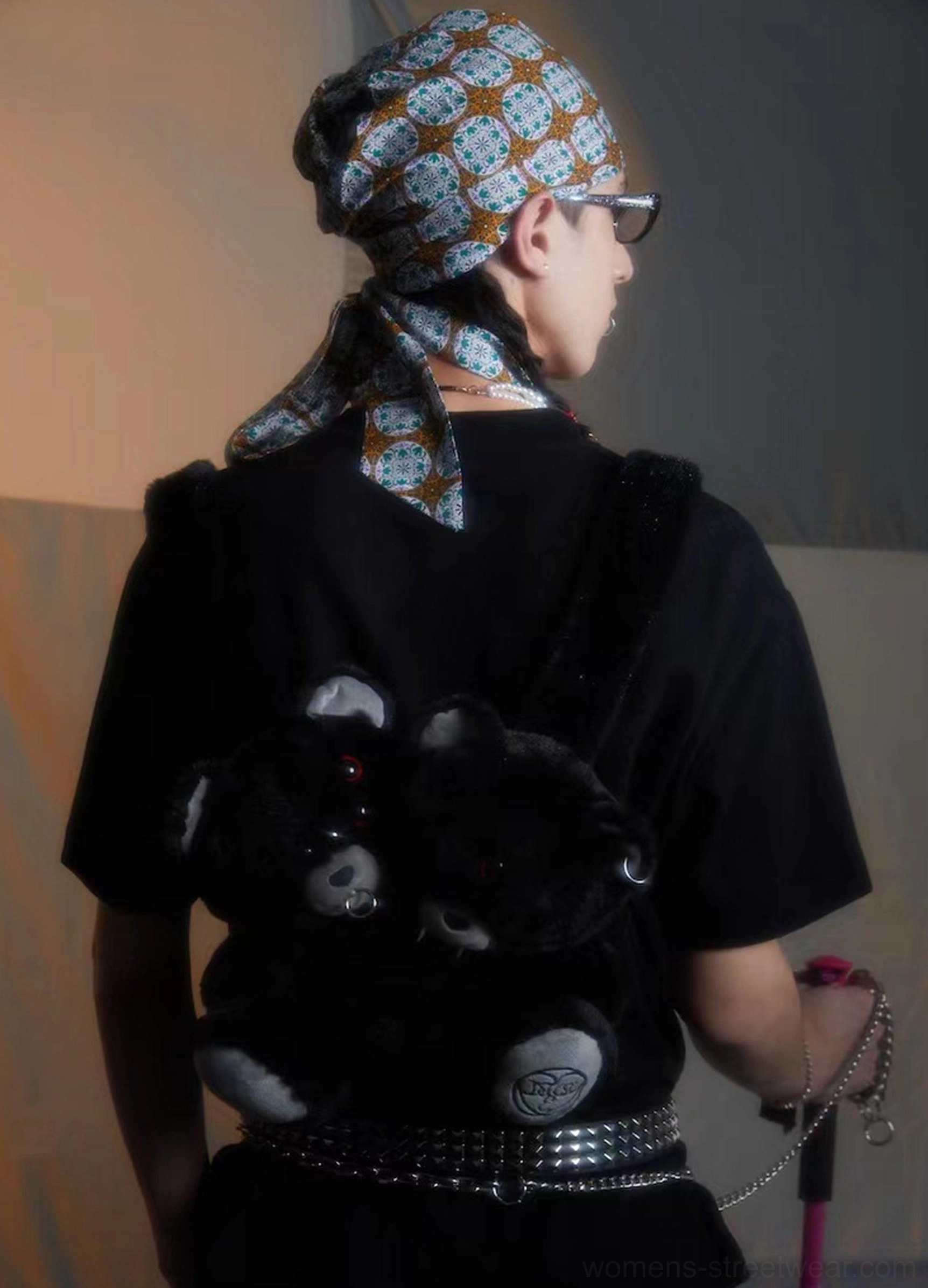 Black twin evil bear faux fur mini backpack worn low on a male model back with dark punk streetwear styling