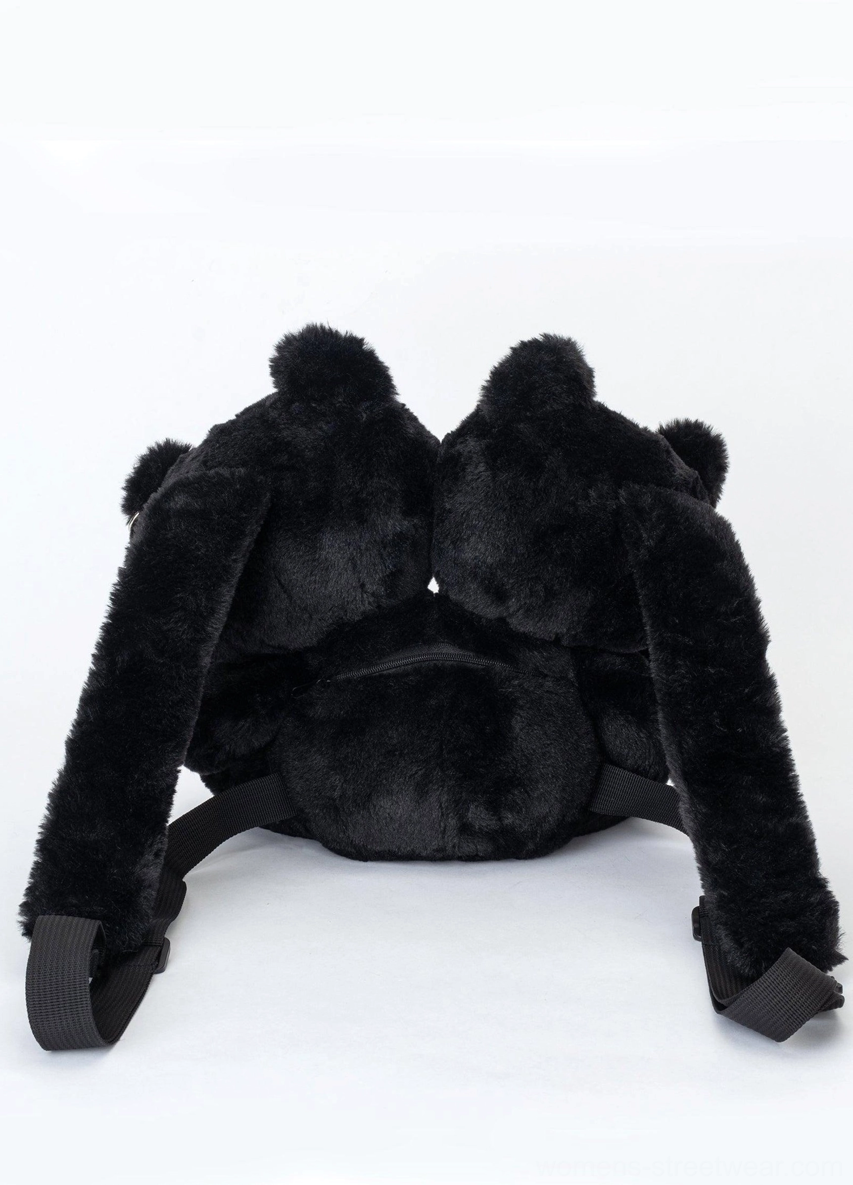 Rear flat lay view of black twin evil bear faux fur mini backpack showing adjustable black webbing shoulder straps