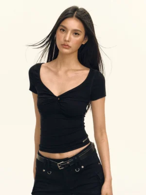 Black twist front deep scoop neck cropped top shown in a front half-body studio view with fitted short sleeves and a sculpted sweetheart neckline
