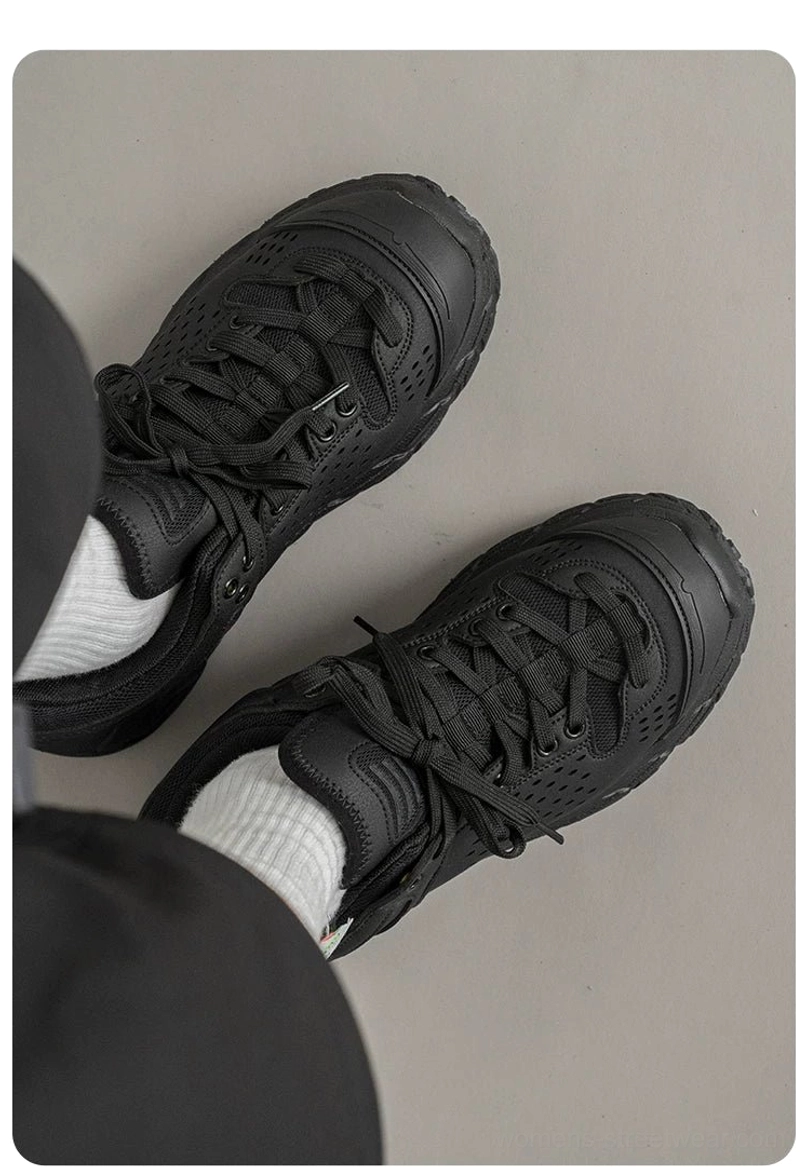 Pair of black utility hiking trainers displayed from an angled top view with lace-up fastening breathable perforated panels and thick anti-slip soles