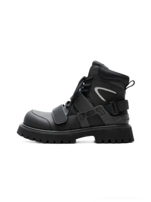 Black Velcro strap lug sole techwear moto combat boots side profile on a white studio background