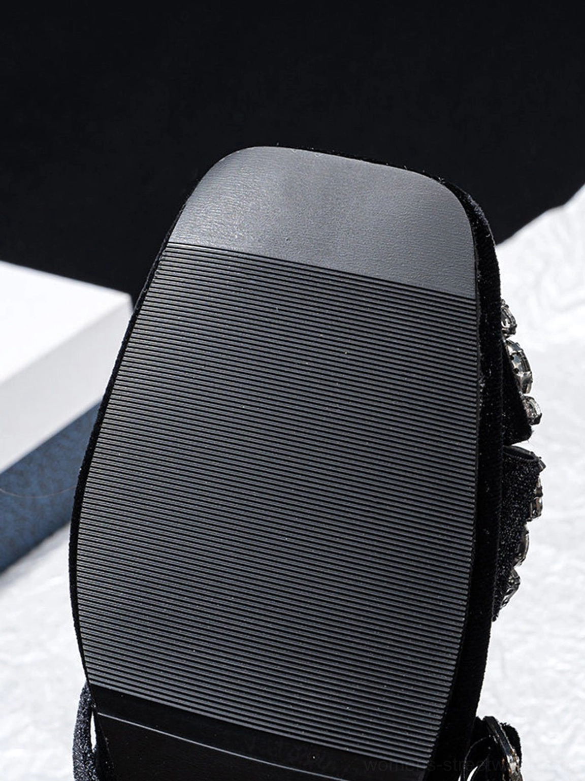 Rubber outsole and rhinestone block heel detail of black velvet crystal bow Mary Jane pumps