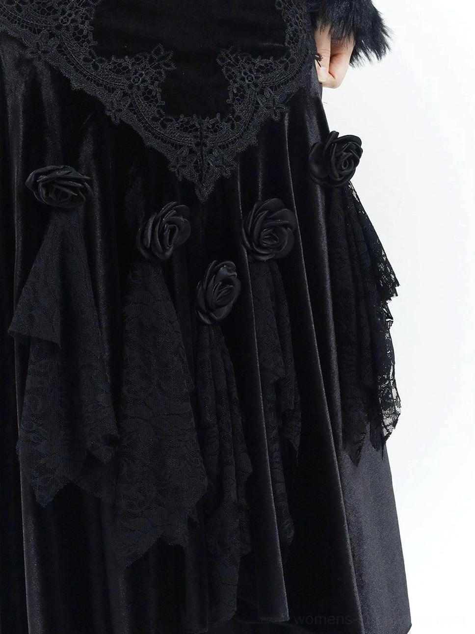 Close-up of black velvet gothic dress fabric featuring vintage lace panels, three-dimensional roses, floral decoration, and layered ruffle trim