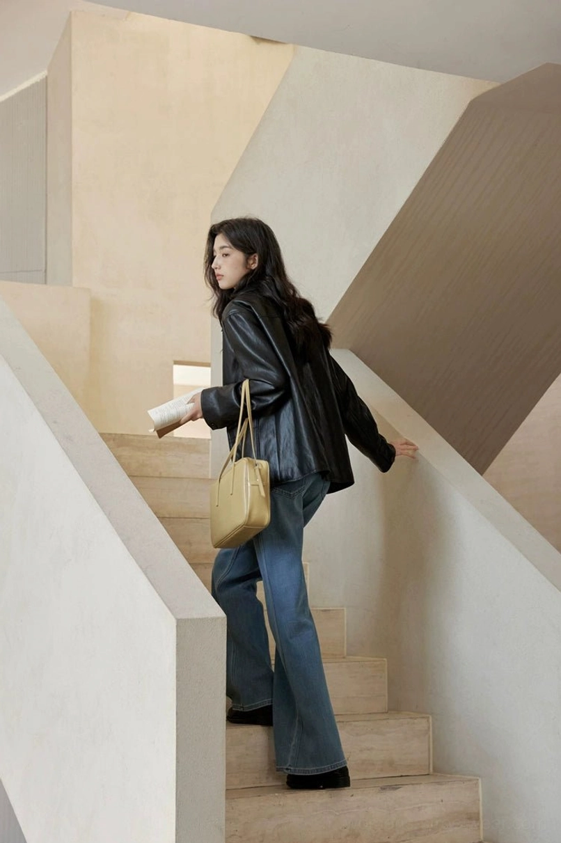 Black vintage leather jacket for women with understated shine and casual polished streetwear appeal