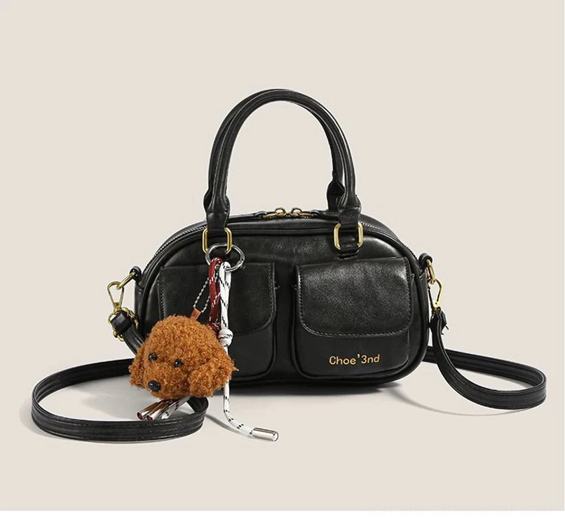 Black vintage puppy charm pocket bowling crossbody bag with double top handles gold hardware front pockets and detachable strap