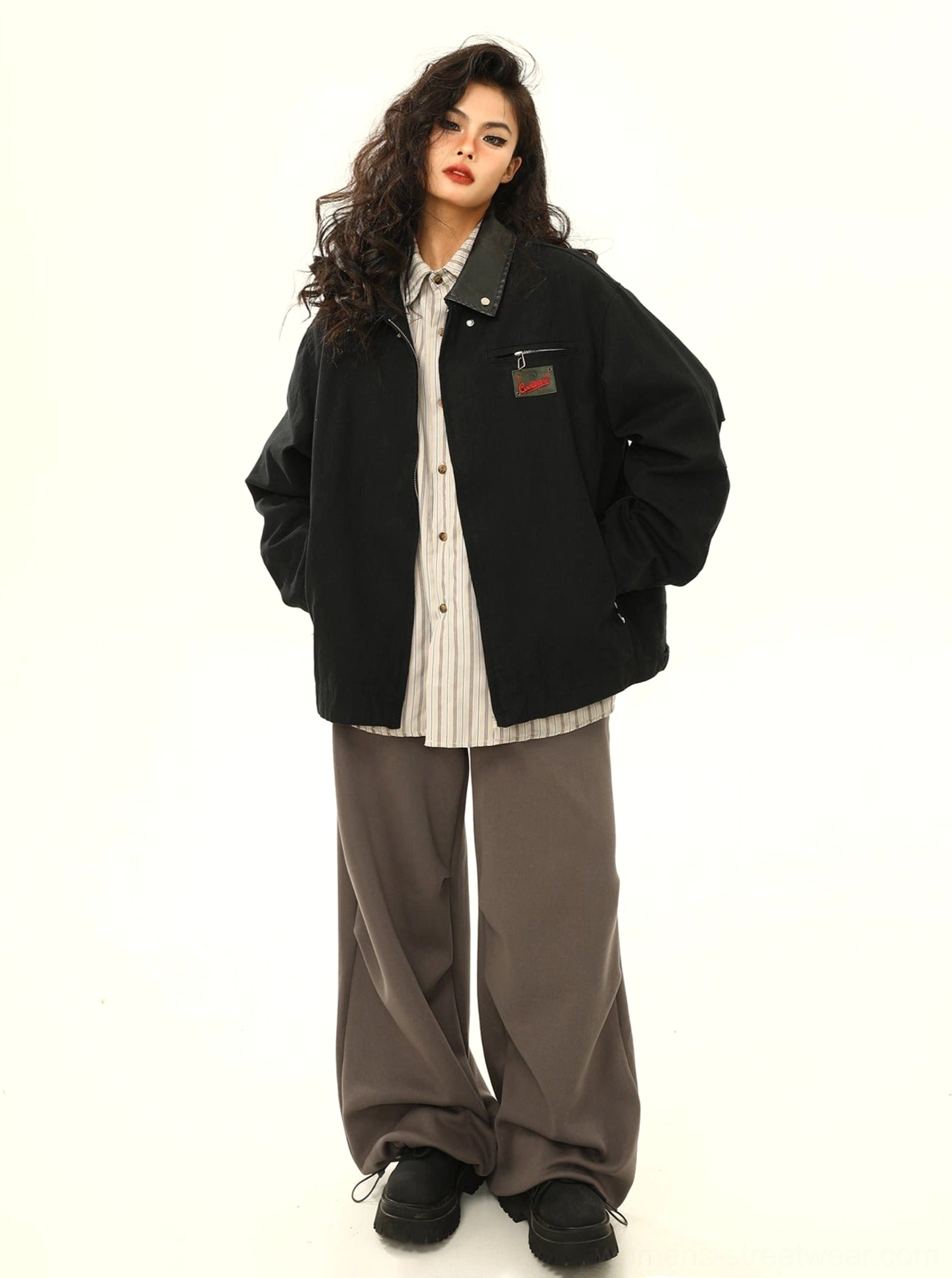 Black vintage streetwear work jacket with contrast collar, embroidered chest badge, relaxed sleeves, and full-body casual styling
