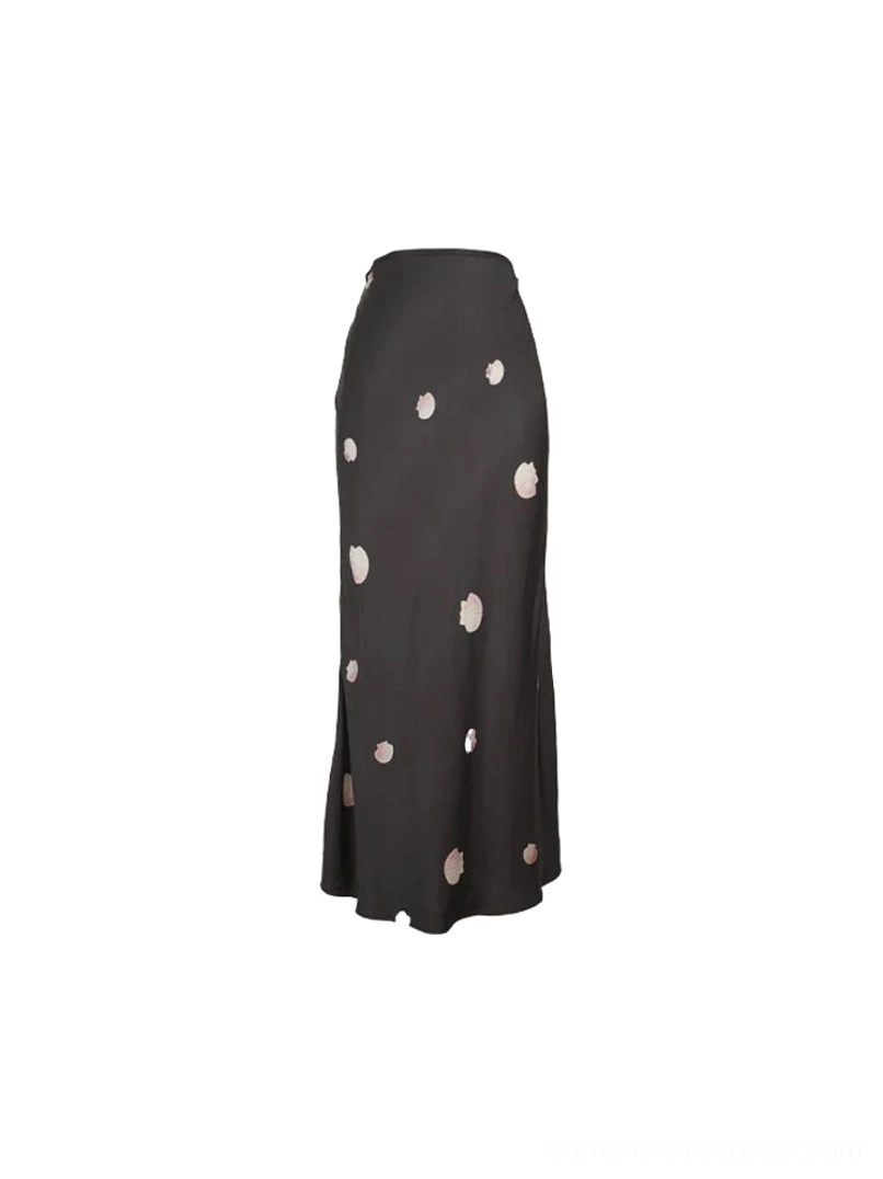 Product-only view of a black viscose floral fishtail maxi skirt with scattered pink flowers on a white background